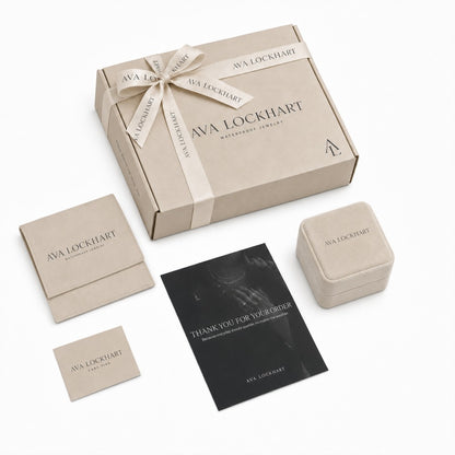 Ava Lockhart gift packaging: East West oval drop earrings and pendant necklace in white velvet boxes with the kraft shipping box, pouch and care card